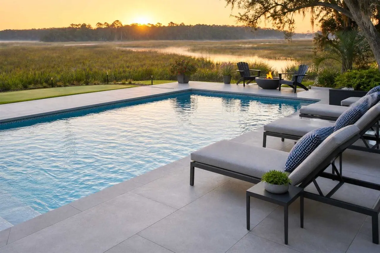 Cohasset, MA - Large-format porcelain pavers create a clean, contemporary pool surround, offering a refined surface that complements the water, furnishings, and open coastal view.