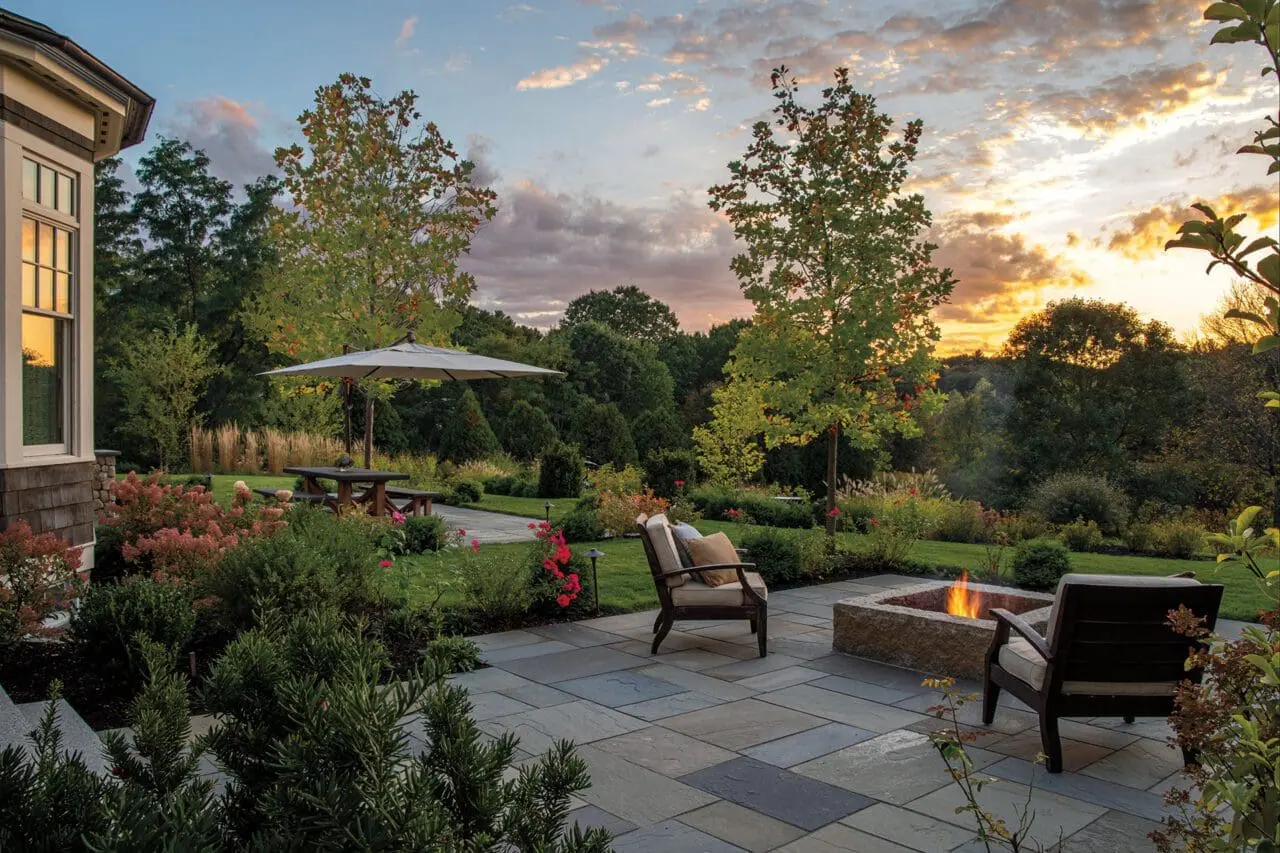 A timeless outdoor space with mature plantings and durable stonework designed to grow more beautiful and functional over time.