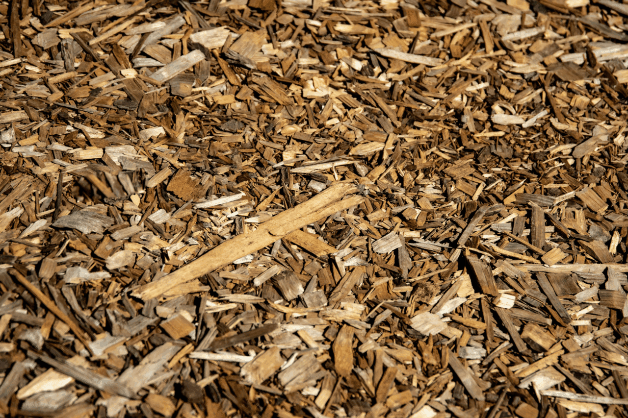 Close-up of wood bark mulch showing coarse brown bark pieces used as a landscape bed covering.