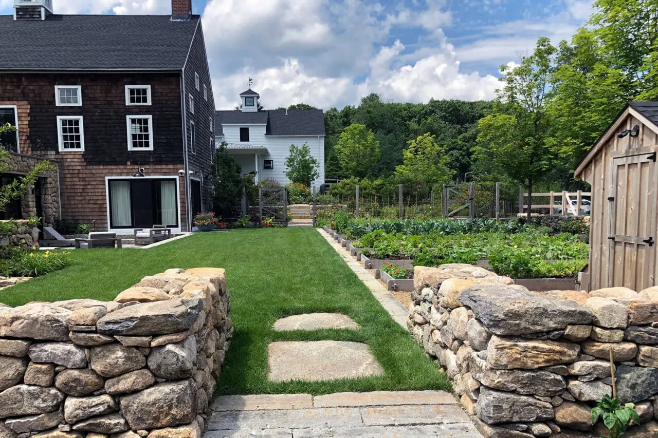 Carlisle, MA - A stone garden entry aligns with the lawn axis, creating clear sightlines and a strong sense of arrival.