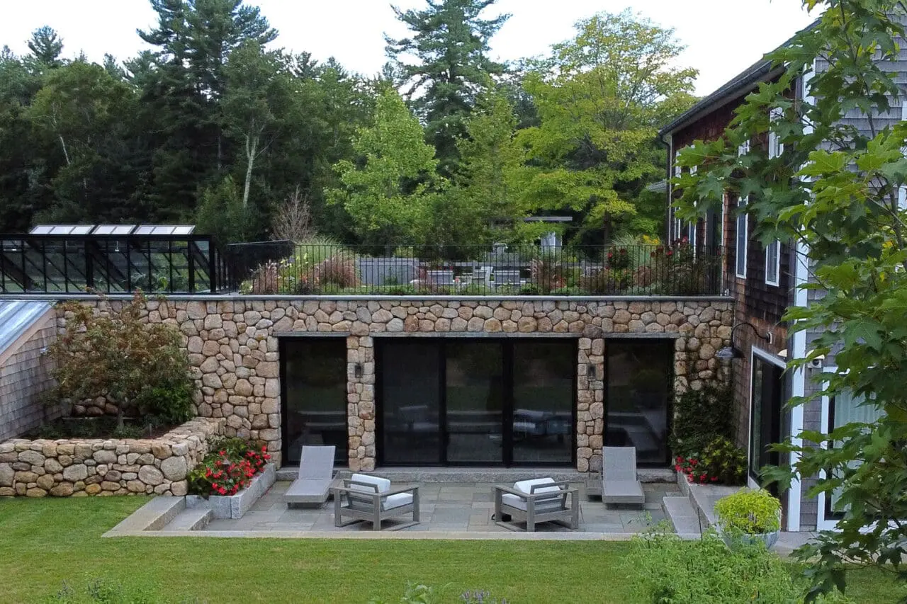 Carlisle, MA - Stone walls shape a sheltered seating zone, emphasizing comfort, scale, and connection to surrounding gardens.