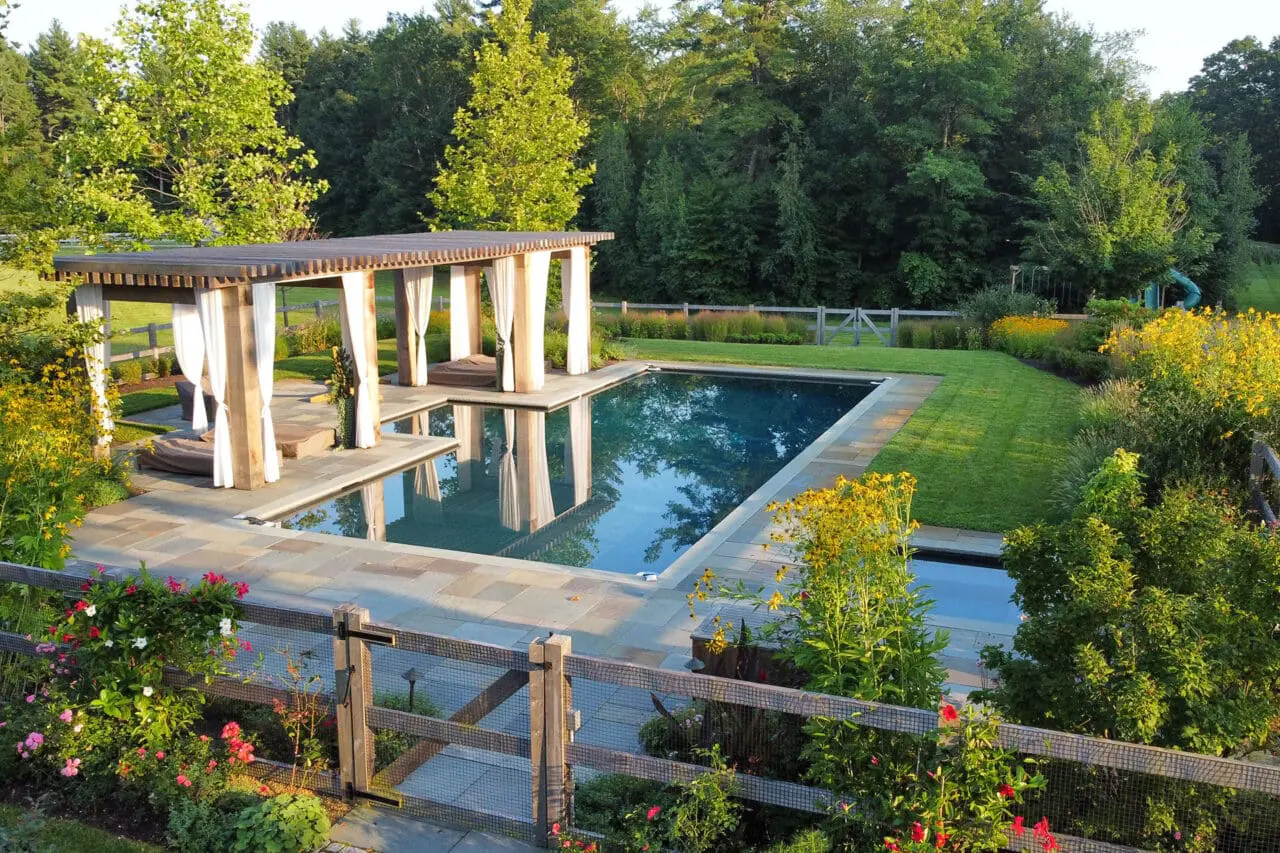 Carlisle, MA - The pool terrace transitions toward open meadow plantings, balancing refined outdoor living with the surrounding rural landscape. Photo: Michael J. Lee