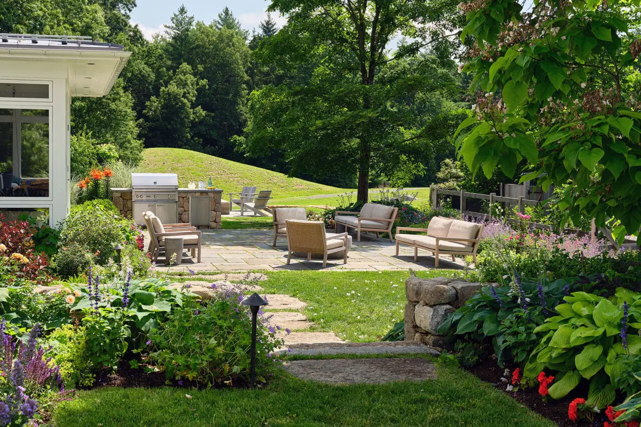 Carlisle, MA - A stone patio functions as an outdoor room, with seating arranged to encourage gathering and framed by structured garden borders. Photo: Sean Litchfield