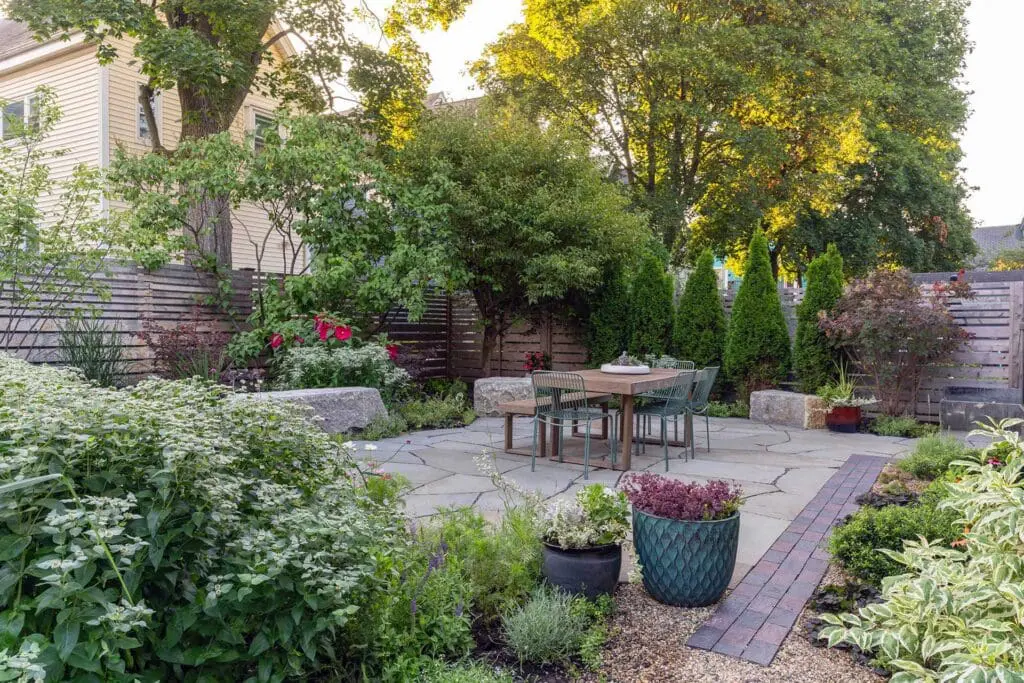 Cambridge, MA - Large-format stone paving defines a flexible gathering space, with planting beds integrated to balance structure and softness throughout the patio. Photo credit: Dan Kaplan