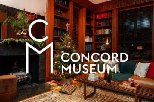 Holiday-decorated library with a Christmas tree, wrapped gifts, evergreen mantel garland, and a fireplace, overlaid with the Concord Museum logo.
