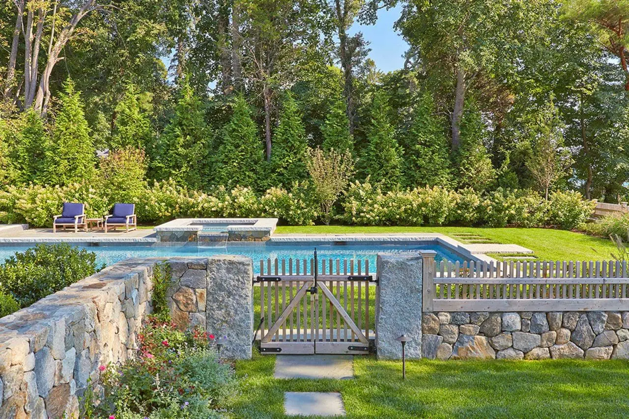 Duxbury, MA - stone masonry walls hardscaping with pool, stone fencing and gardens