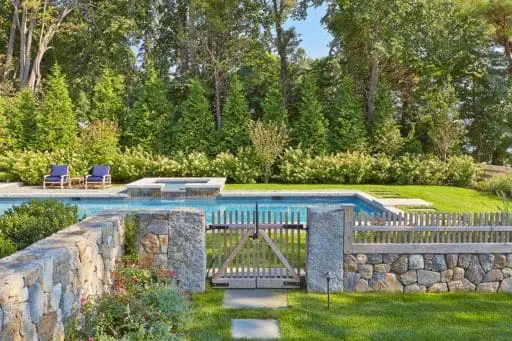 Duxbury, MA - stone masonry walls hardscaping with pool, stone fencing and gardens