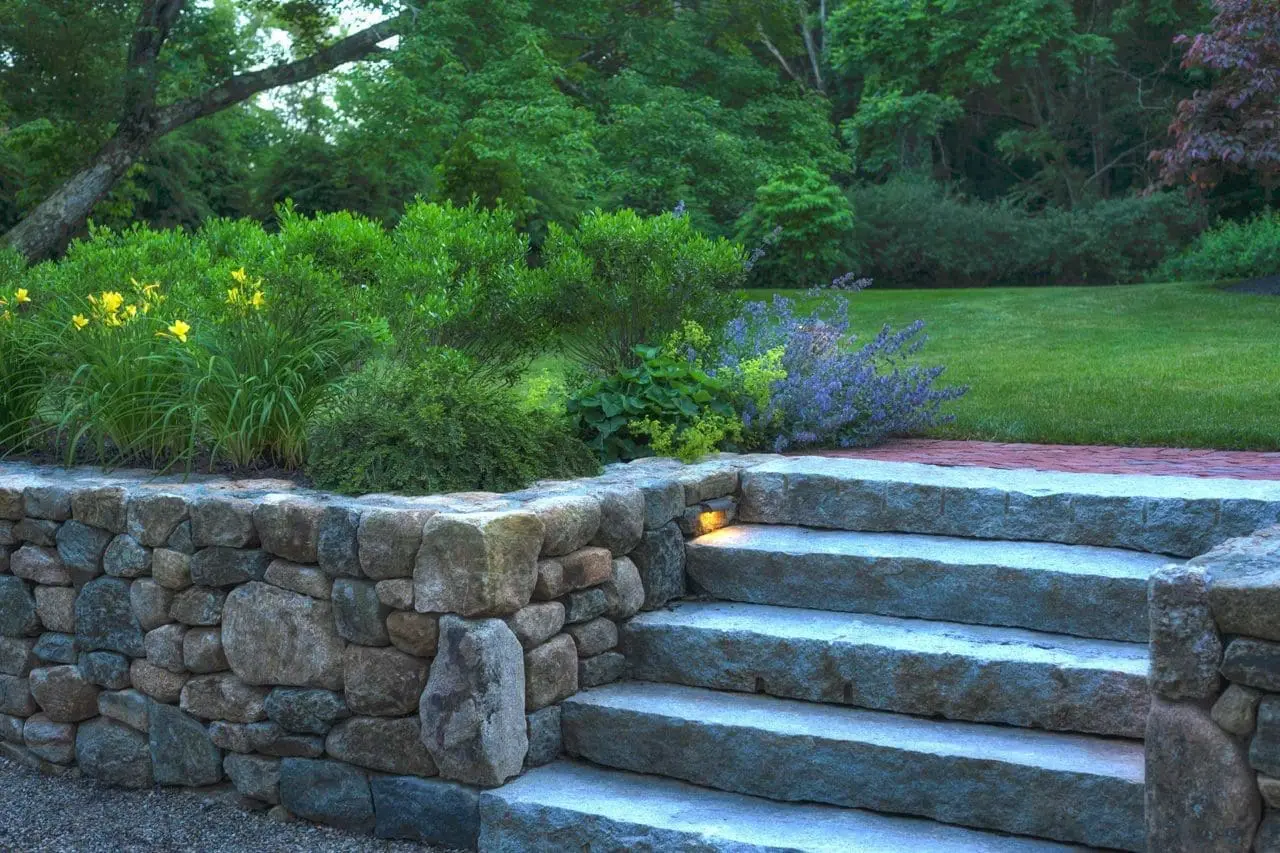 Lincoln, MA - Hidden landscape lighting illuminates this antique granite stairway.