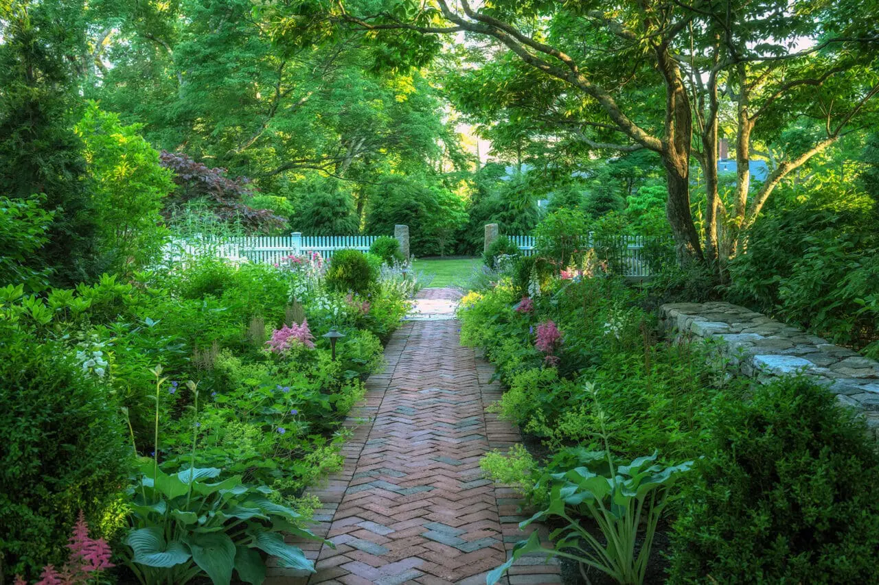 Lincoln, MA - Brick herringbone path adds texture and tradition, guiding movement through shaded planting in Weston.