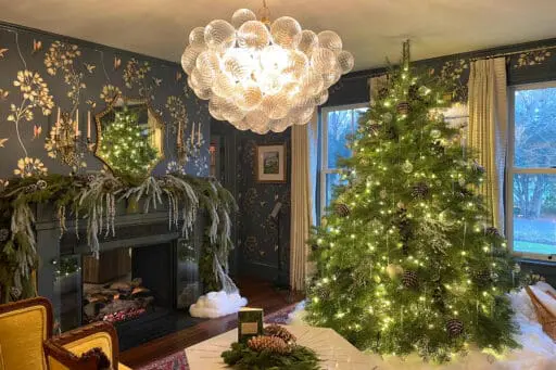 Elegant Wellesley living room decorated with a Christmas tree, fireplace greenery, and understated holiday accents.