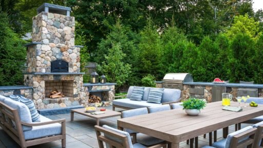 Summer garden party setting with an outdoor dining table surrounded by lush seasonal plantings and a well-maintained residential landscape.