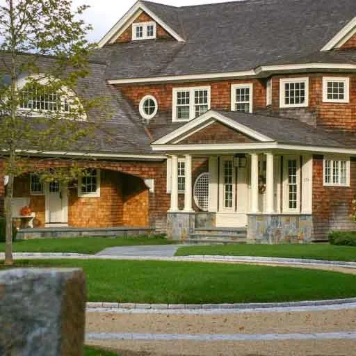 Duxbury , MA - A circular driveway pairs elegant masonry, structured planting, and a graceful arrival sequence that enhances curb appeal and daily function.
