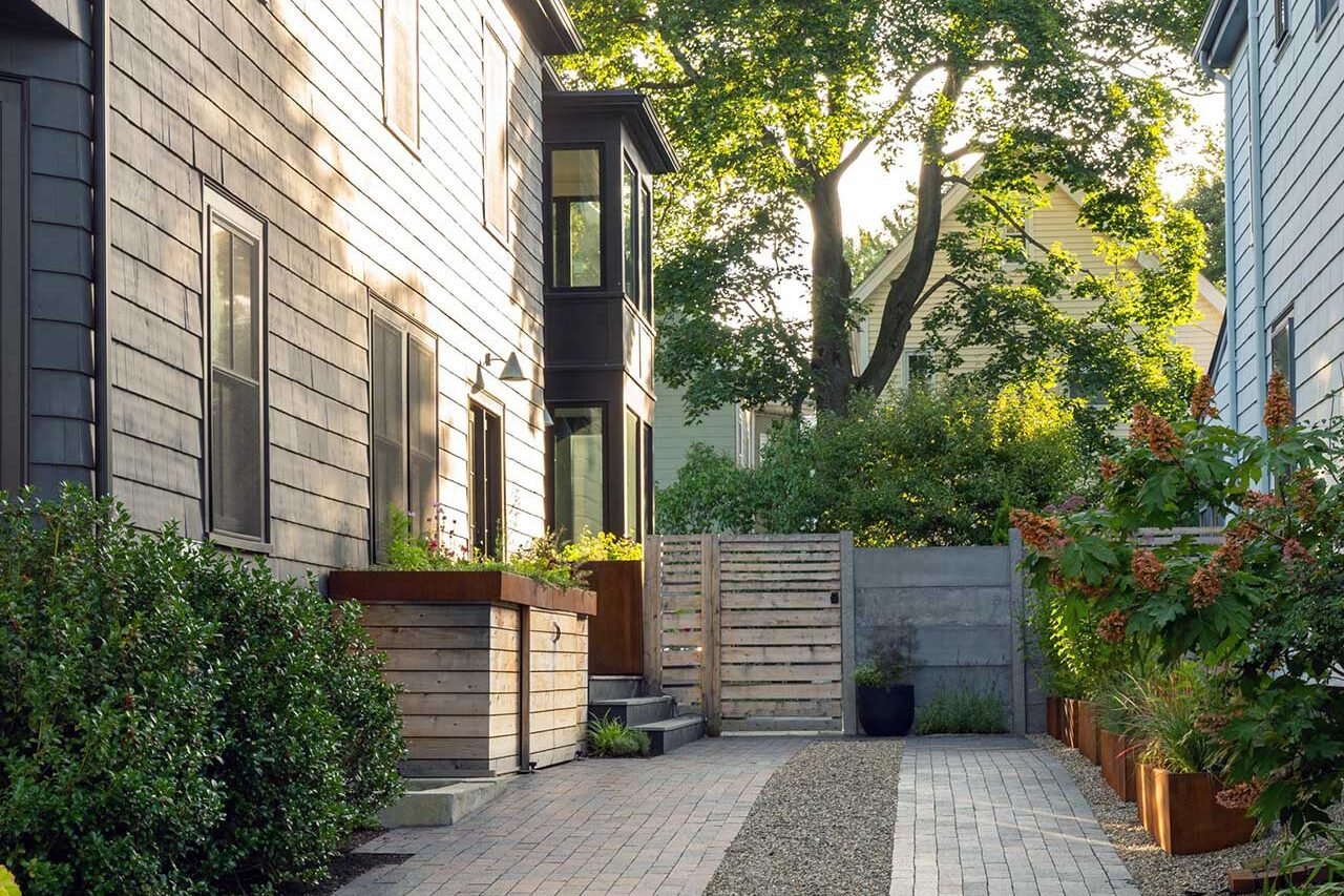 Cambridge, MA - Permeable pavers with a central gravel band improve drainage while reinforcing the linear geometry of this narrow urban driveway, complemented by layered privacy screening. Photo credit: Dan Kaplan