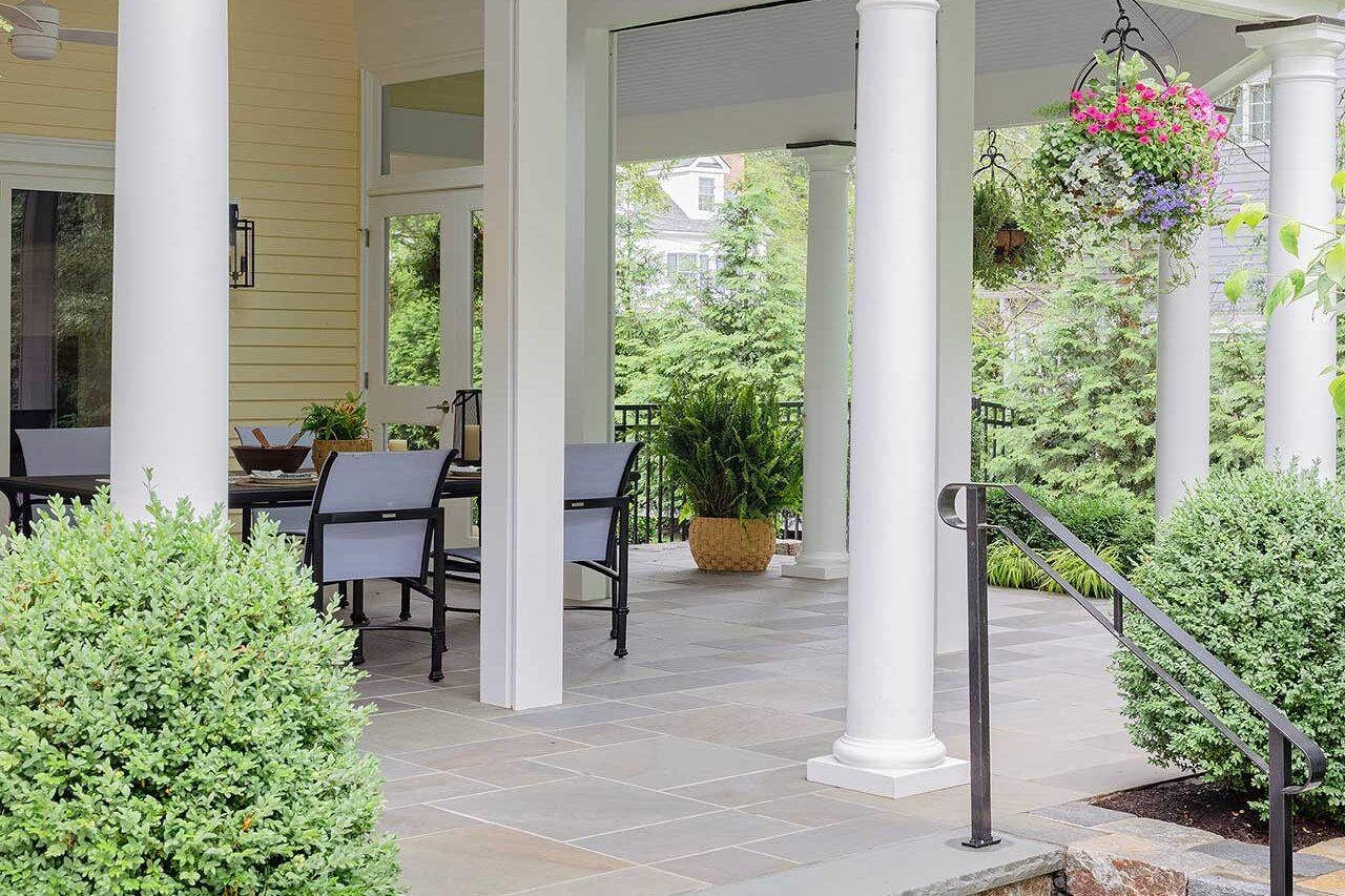 Wellesley, MA - Stone steps, clean masonry, and clipped evergreen structure lead gracefully into the screened porch and connect the home to the broader landscape. photo credit: Michael J Lee