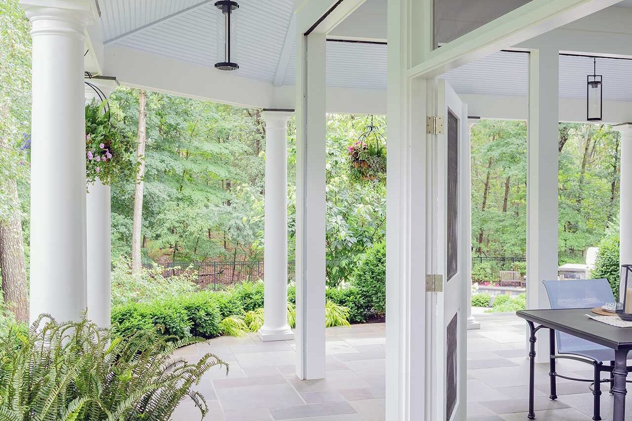 Wellesley, MA - Bluestone flooring and a sheltered colonnade create a refined transition space that links the architecture to the surrounding garden and pool terrace. photo credit: Michael J Lee