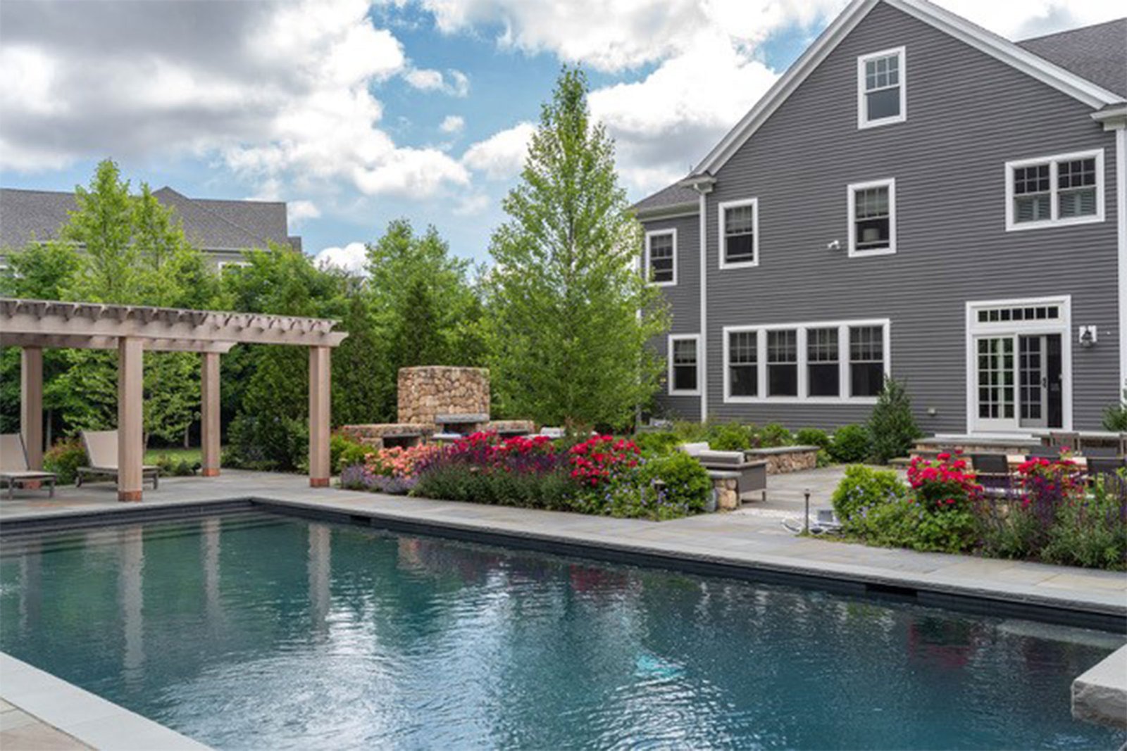 Winchester backyard with pool, pergola, and outdoor fireplace