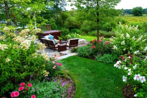 A butterfly garden surrounds the country farmhouse with nectar-rich flowers and layered plantings designed to attract butterflies and other pollinators.