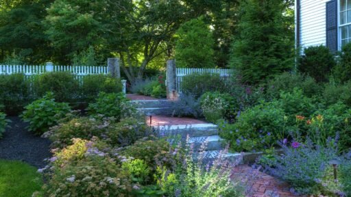 Lincoln, MA - This Lincoln garden pairs lush planting beds with natural stone edging for a refined, well-structured New England landscape.