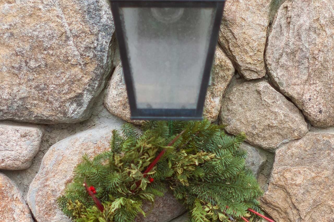 This mixed evergreen wreath offers a more natural holiday look, with red berry accents adding just enough seasonal color.