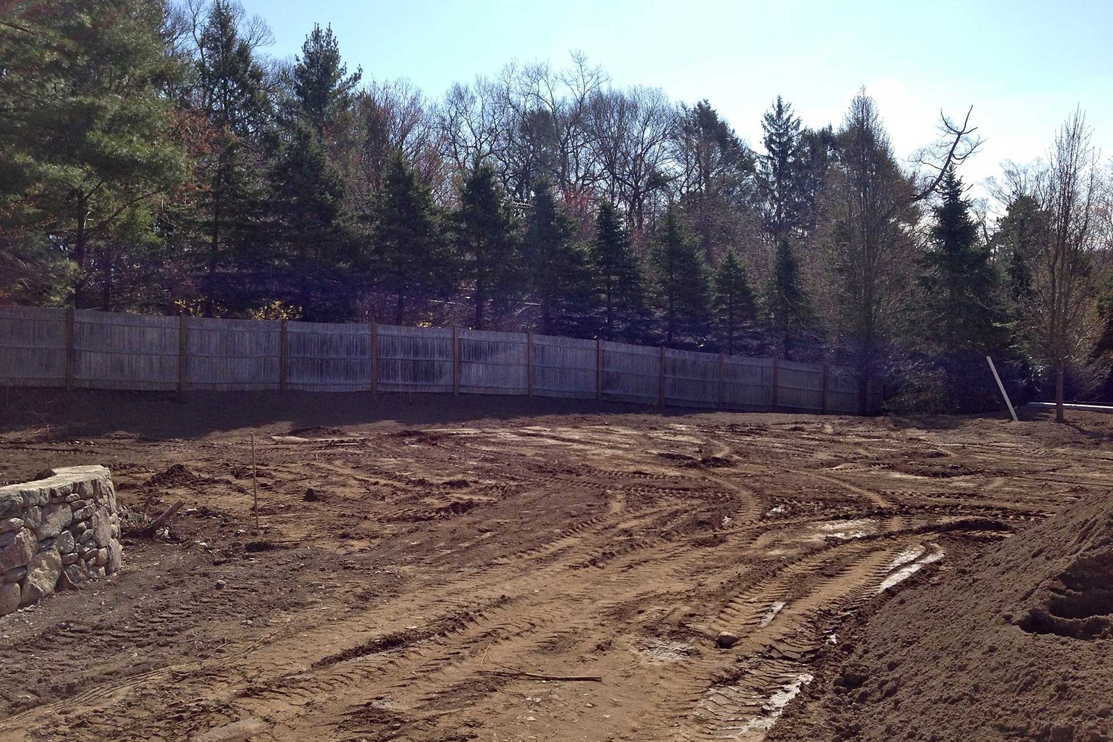 Needham backyard under construction before lawn and screening installation