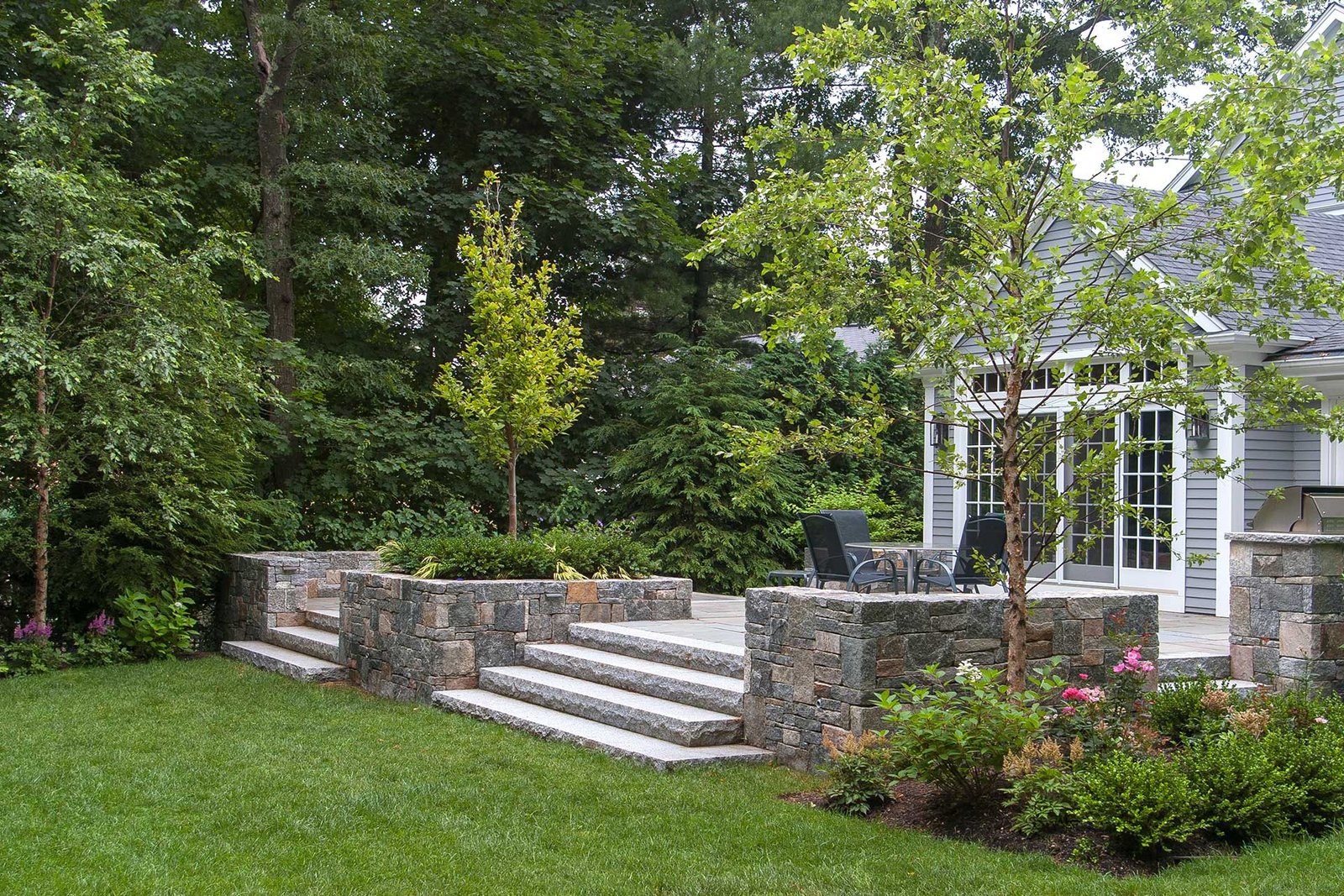 Wellesley finished backyard with stone terrace and plantings