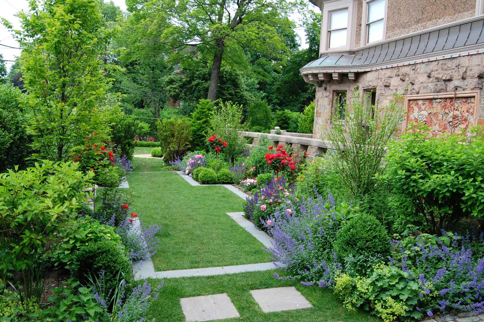 Brookline Brownstone finished side garden with lawn path and flowering borders