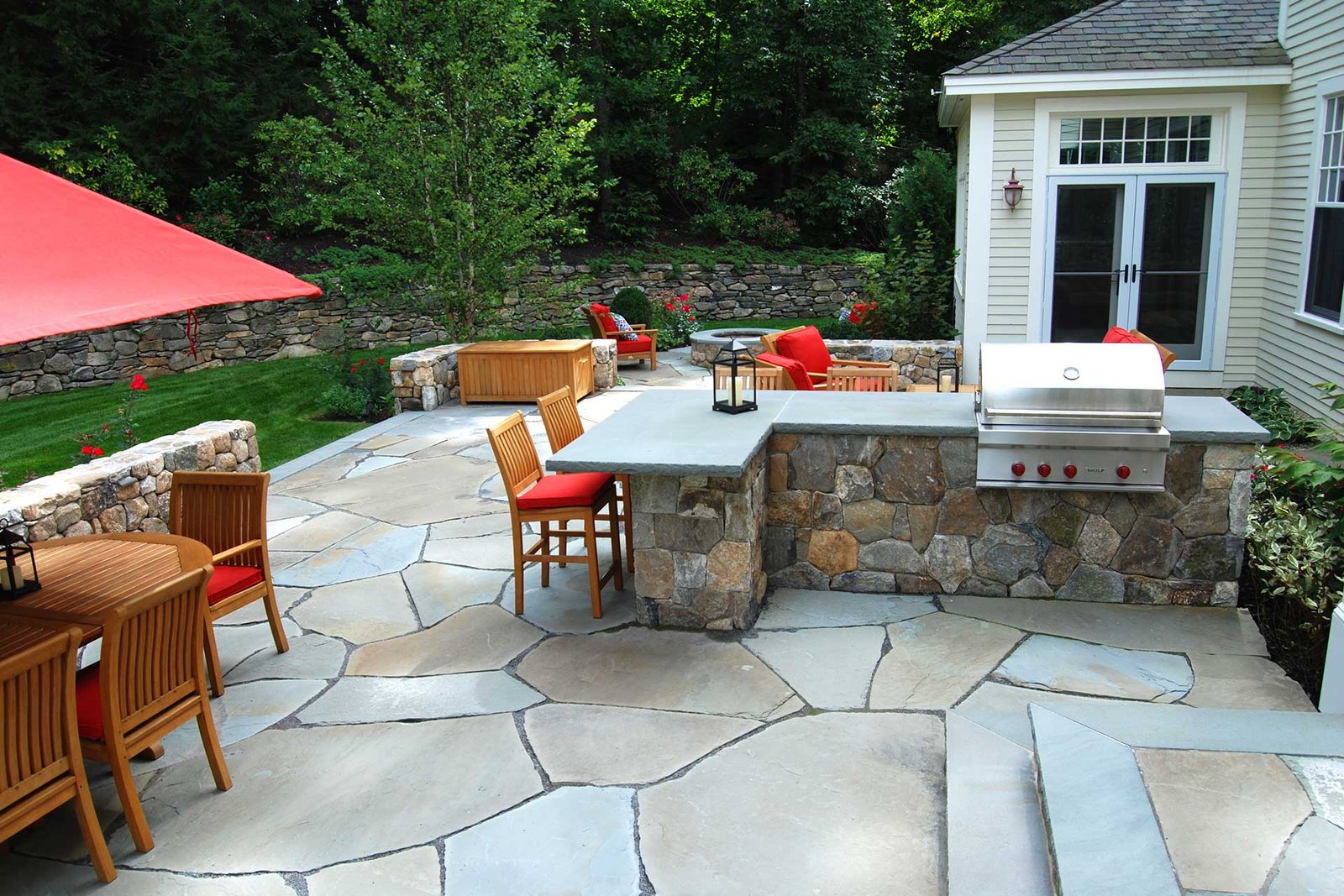 Concord backyard with outdoor kitchen, stone patio, and seating area completed