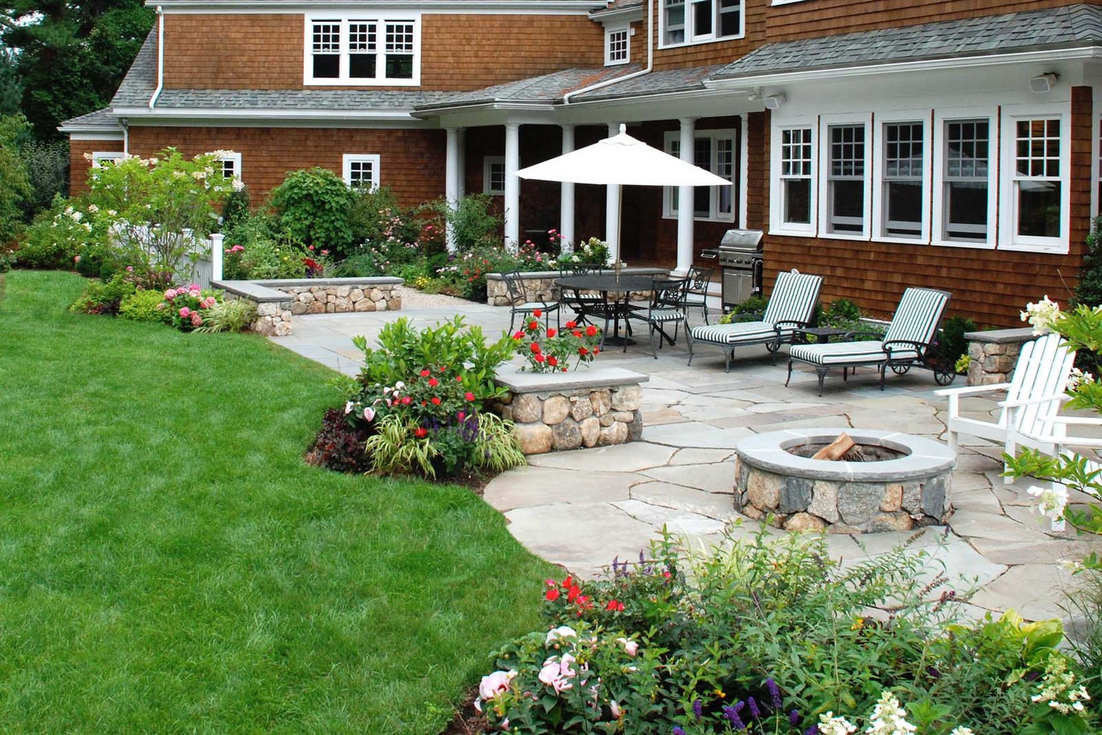 Wayland stone patio with fire pit, seating, and garden planting