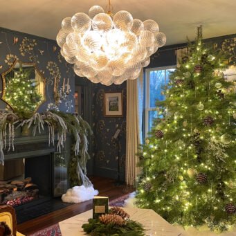 Elegant Wellesley living room decorated with a Christmas tree, fireplace greenery, and understated holiday accents.
